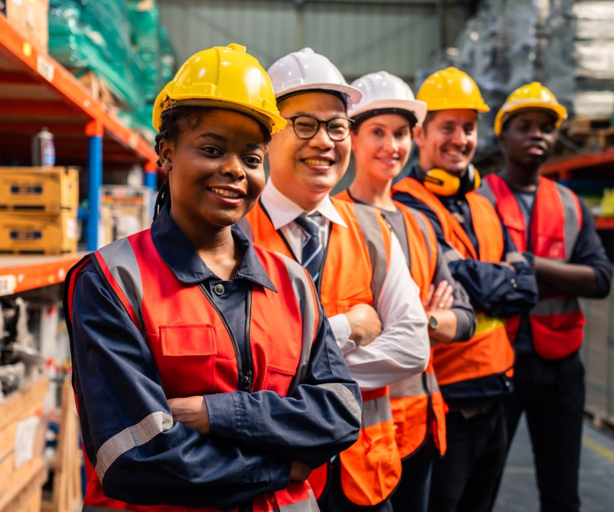 Portrait group of diverse industry worker working in factory warehouse. Young industrial engineer people process orders and product together at manufacturing plant then crossing arm with confidence.